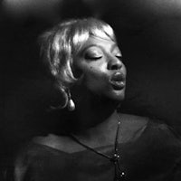 a black and white photo of a woman with her mouth open